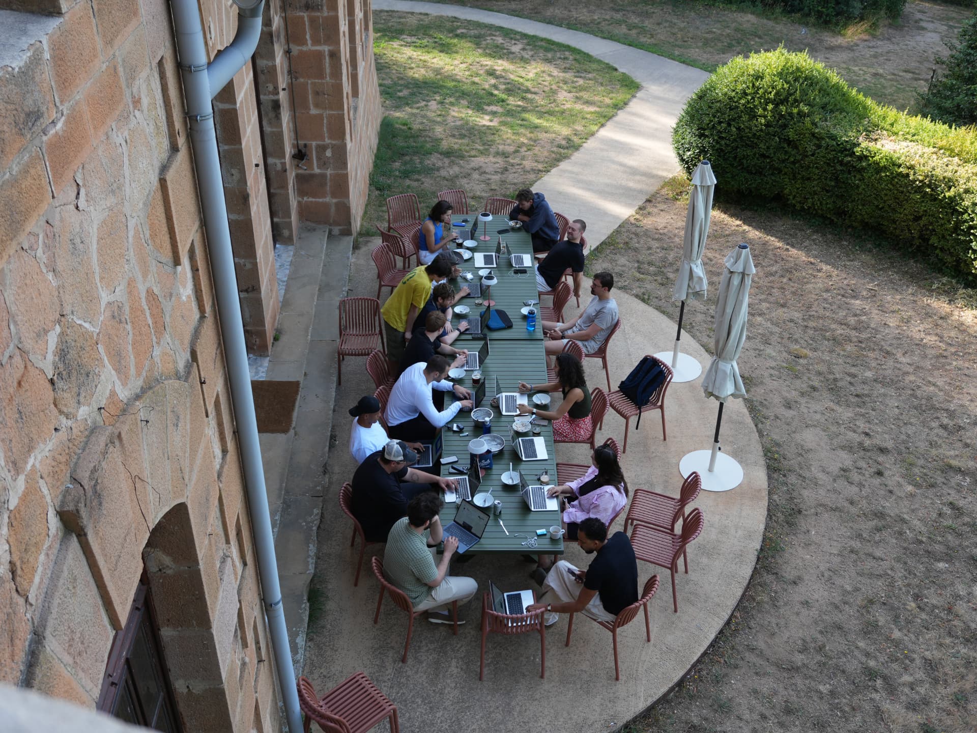 Team working together at a long outdoor table during an offsite