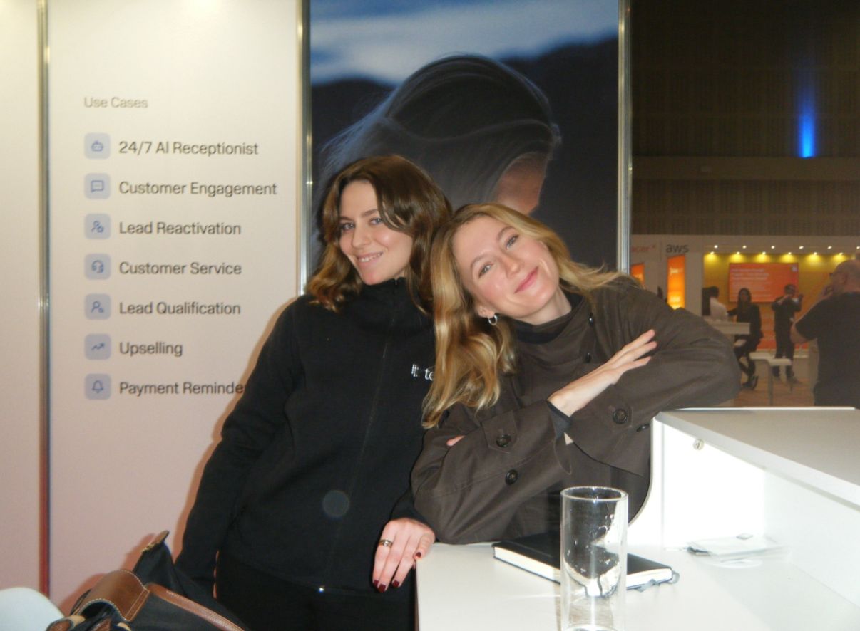 Two teammates at a telli event booth
